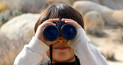 Child looking through binoculars