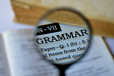 Magnifying glass on the word Grammer