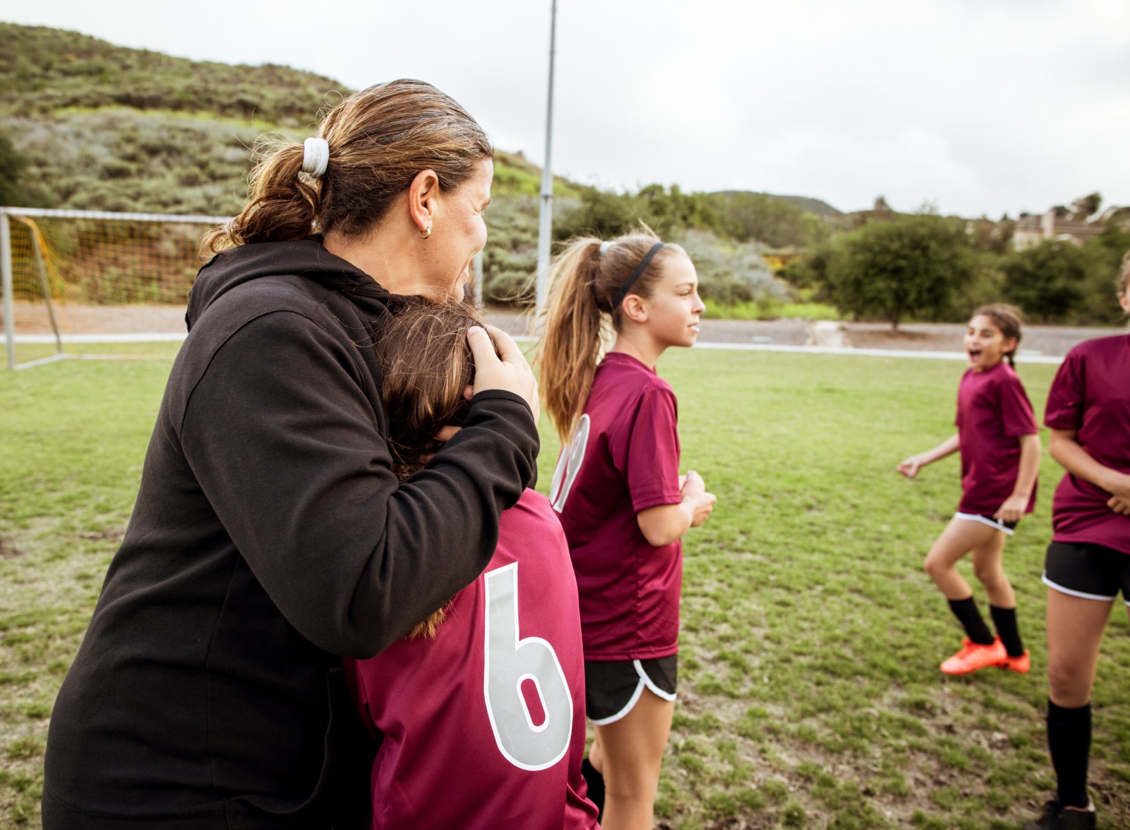 Coach protecting young athlete