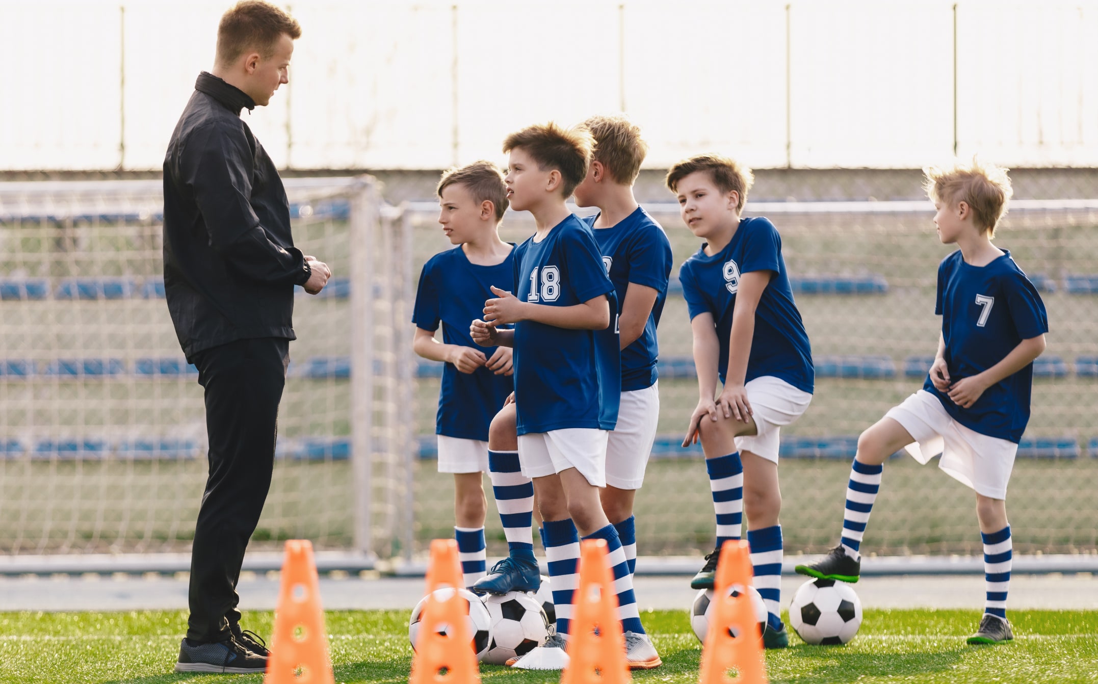 Coach with a group of young soccer athletes