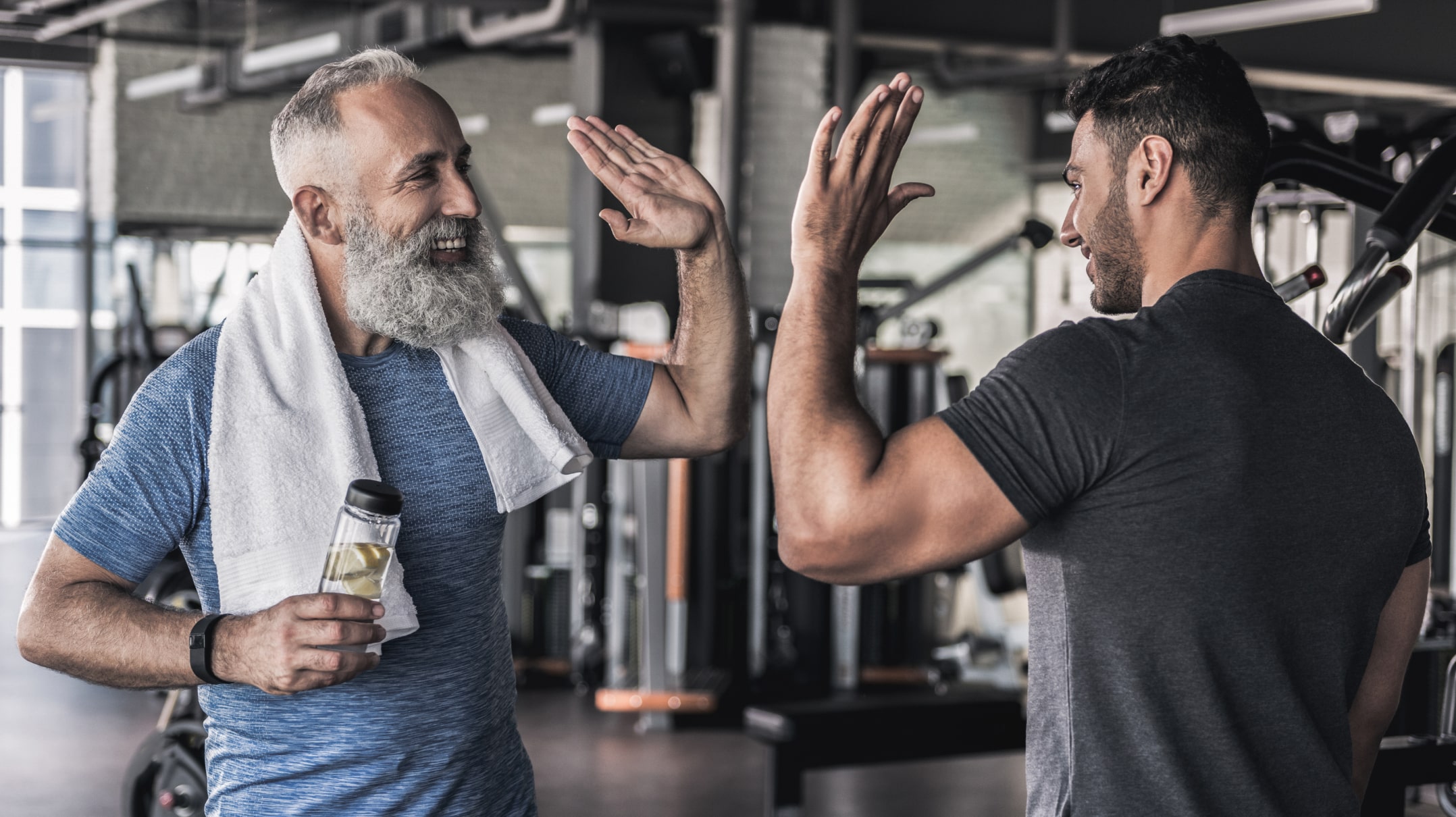 Two people giving high fives at the gym