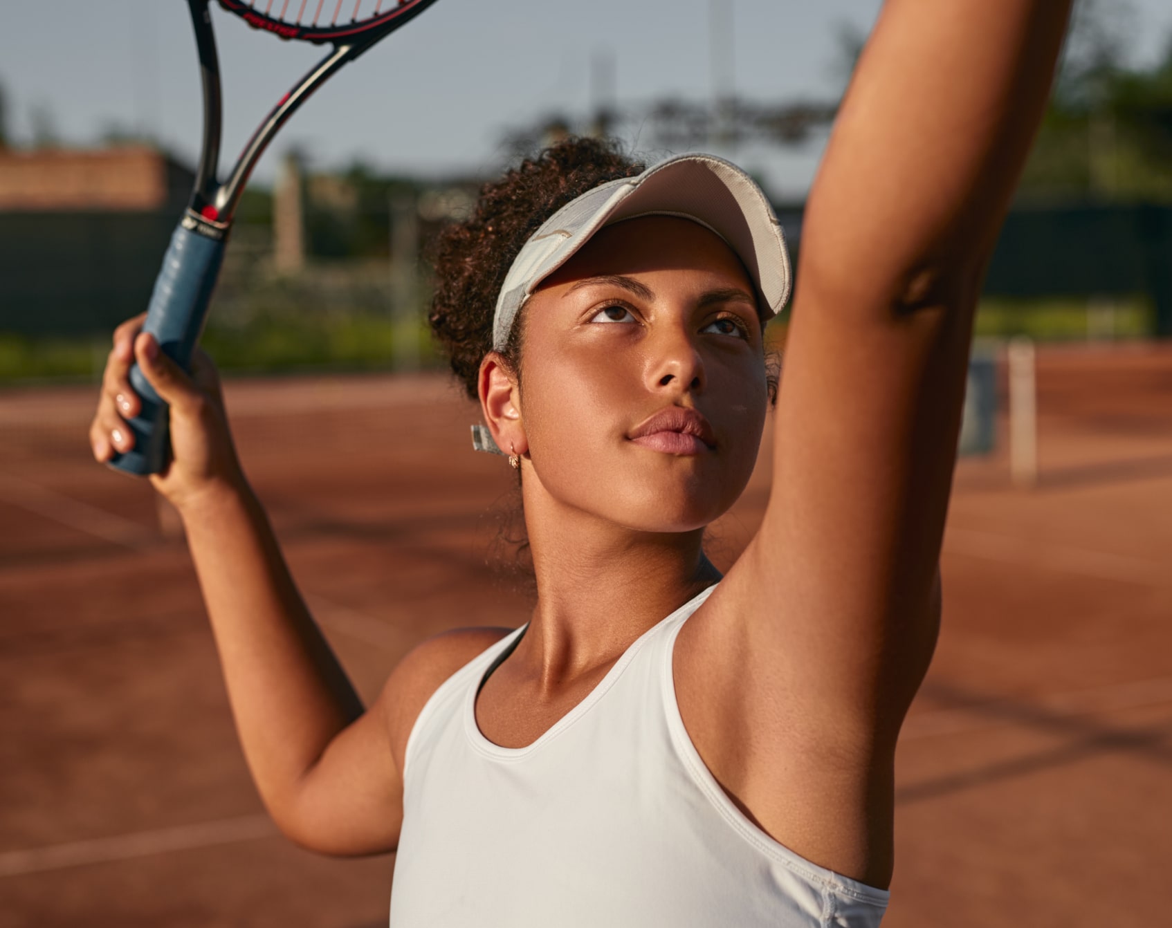 Tennis athles performing a serve.