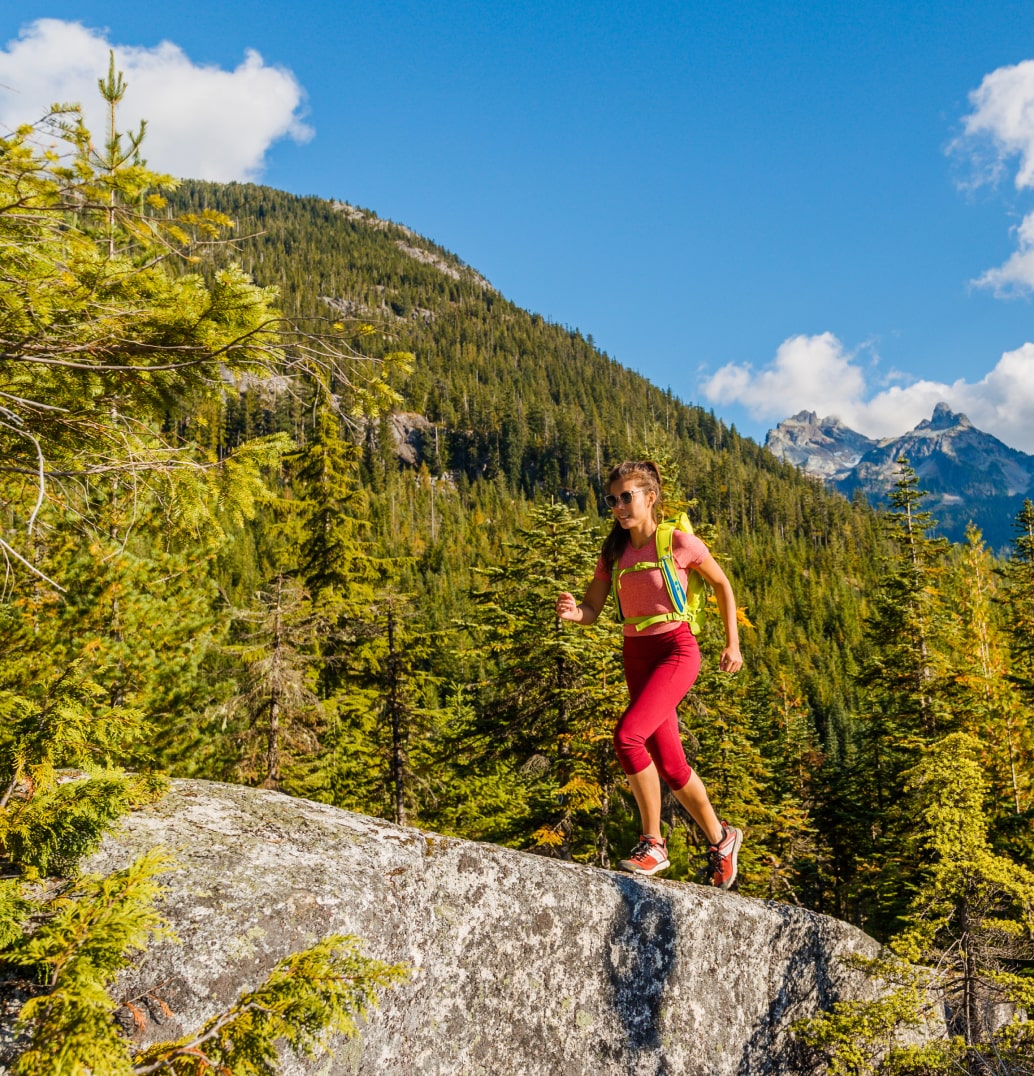 Female athlete hiking up a hill.