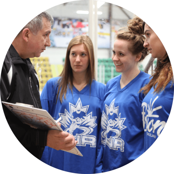 Coach speaking with female athletes