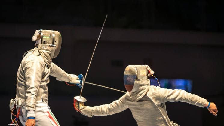 Two people fencing against each other