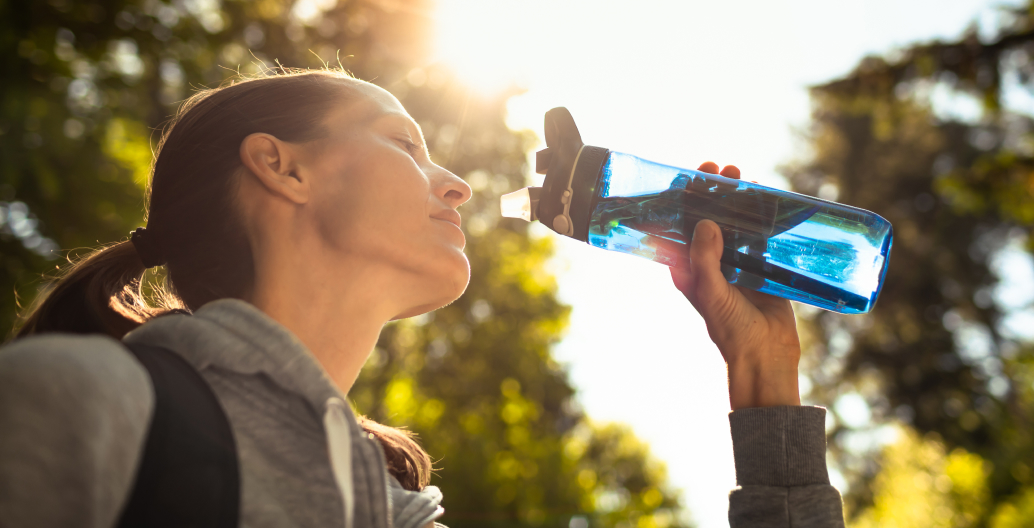 Woman drinking water to stay hydrated