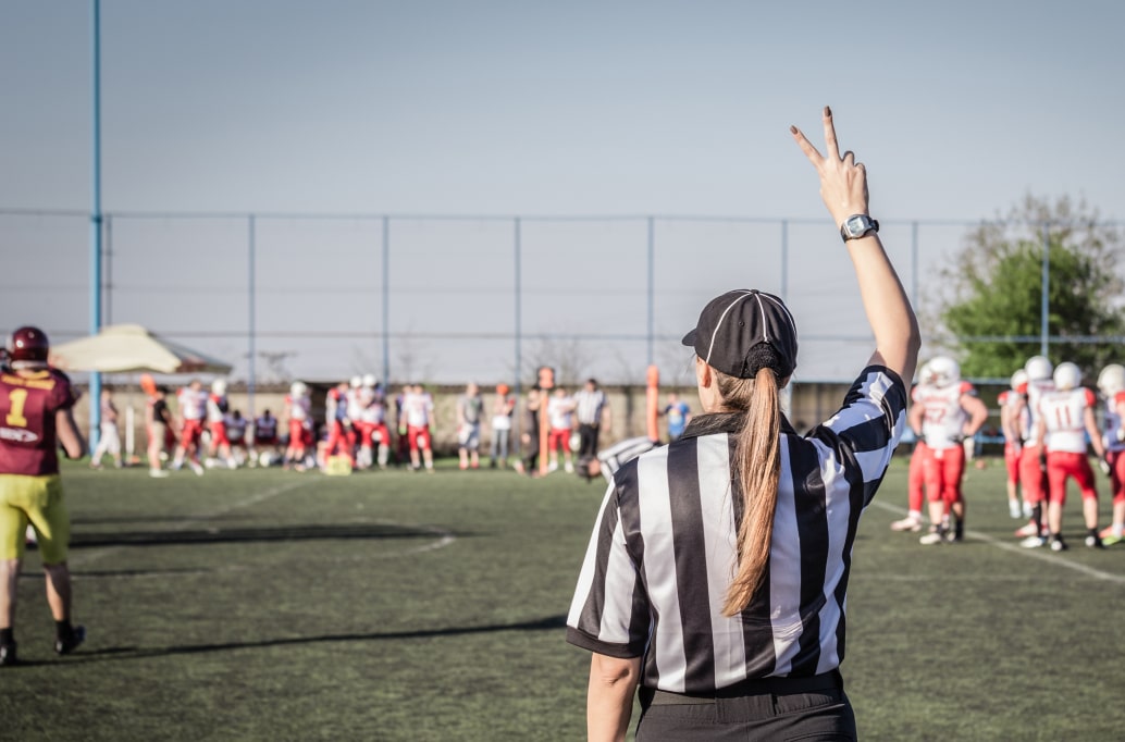 Referee signalling a call during a match in football