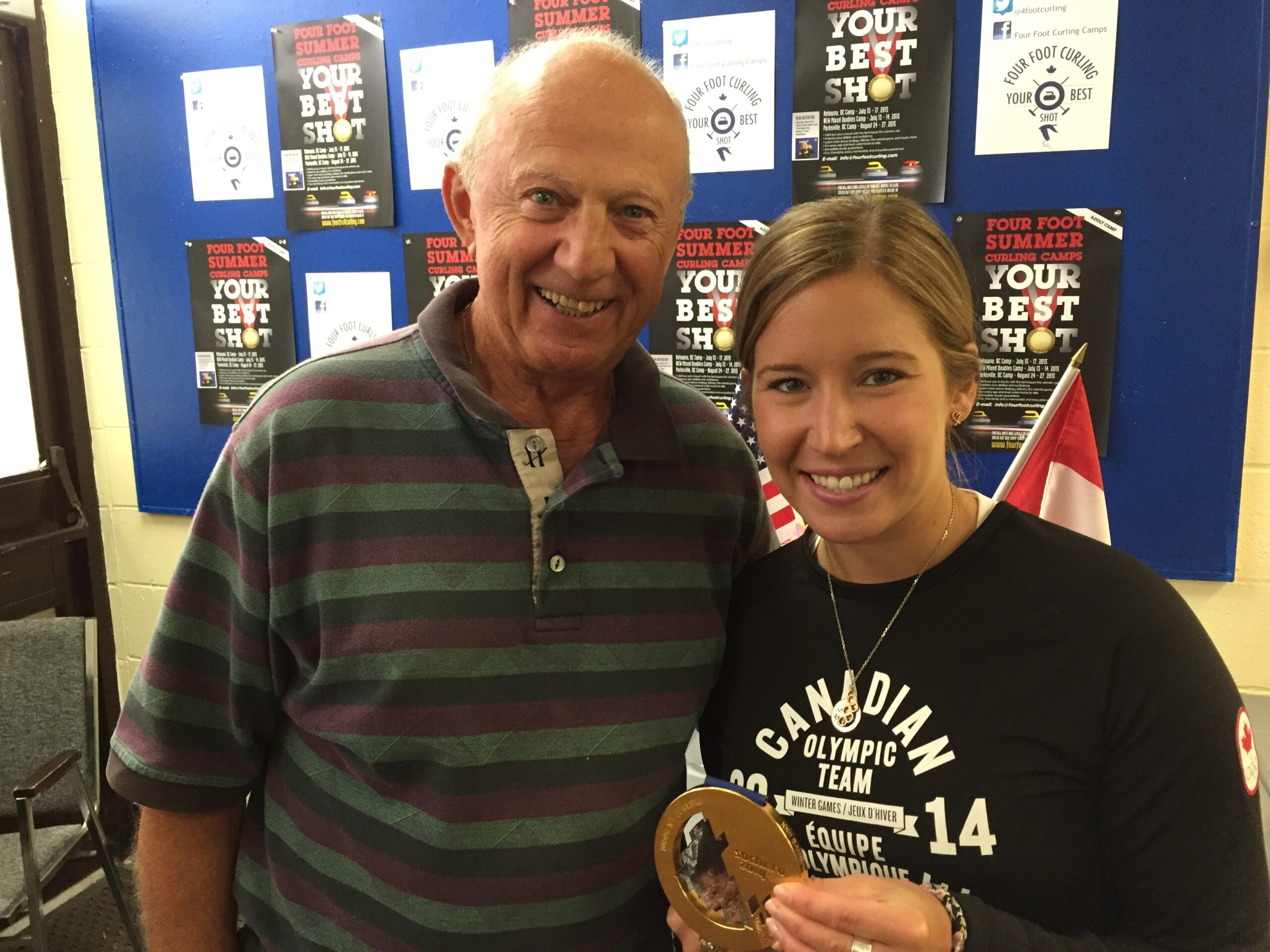 Volunteer smiling beside an award recipient